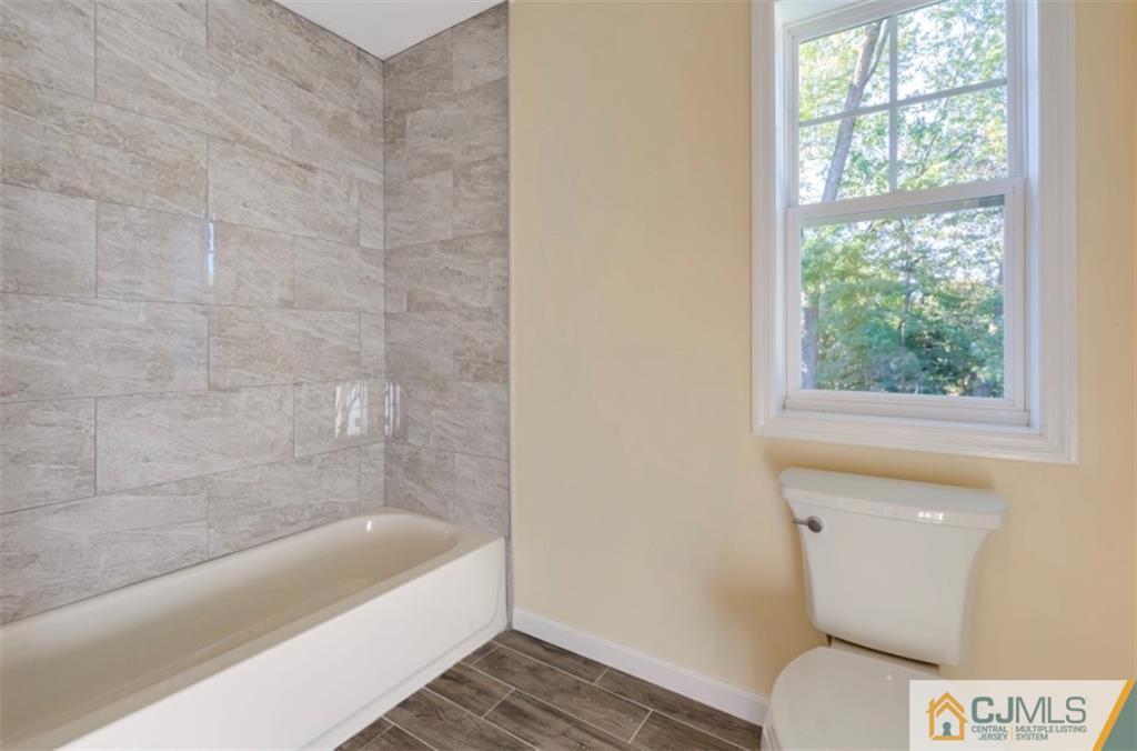 10 Markham Road Edison, NJ 08817 - Photo 22 of 23 a bathroom with a toilet and a bathtub