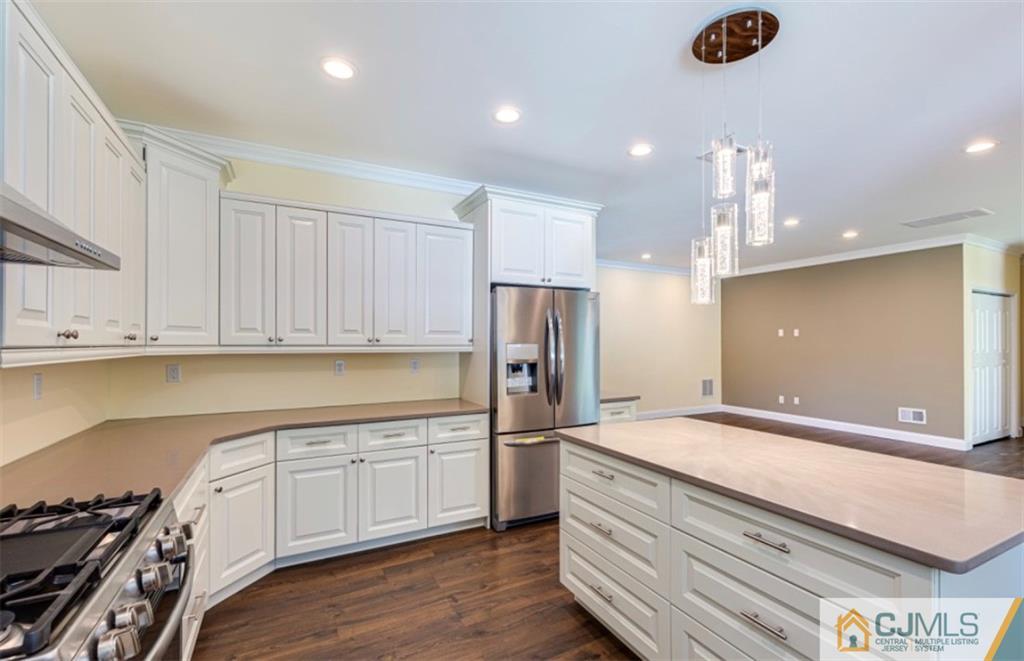 10 Markham Road Edison, NJ 08817 - Photo 5 of 23 a kitchen with stainless steel appliances granite countertop a sink a stove and a refrigerator