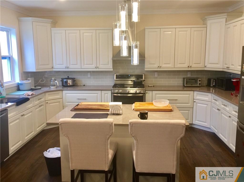 10 Markham Road Edison, NJ 08817 - Photo 6 of 23 a kitchen with a sink cabinets and appliances