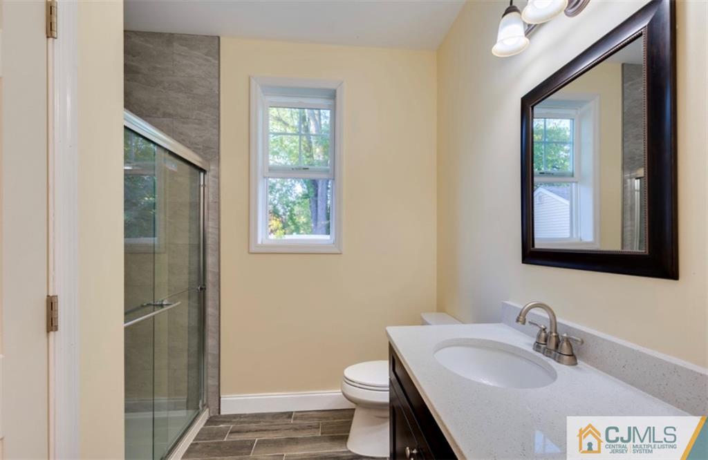10 Markham Road Edison, NJ 08817 - Photo 9 of 23 a bathroom with a sink and a mirror