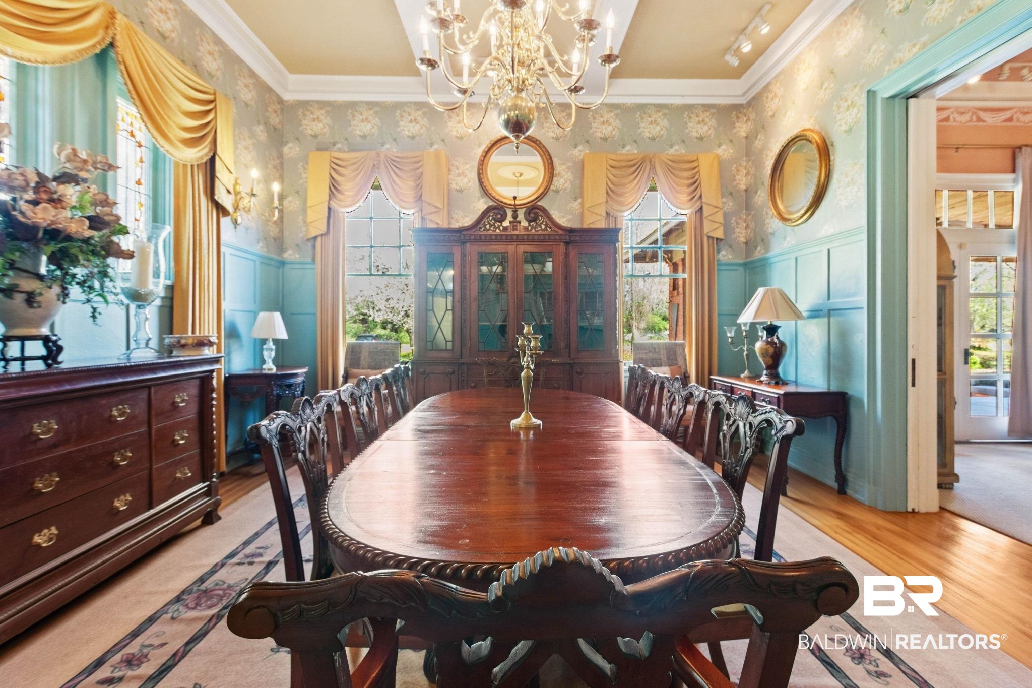 1701 Sowell Road Brewton, AL 36426 - Photo 29 of 83 Dining room with a chandelier, crown molding, light wood-style flooring, wallpapered walls, and a decorative wall