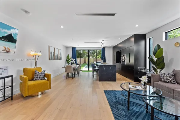 a living room with furniture and a wooden floor