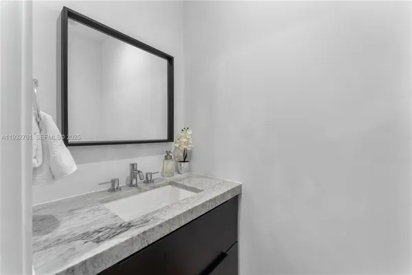 a en suite bathroom with a sink and mirror