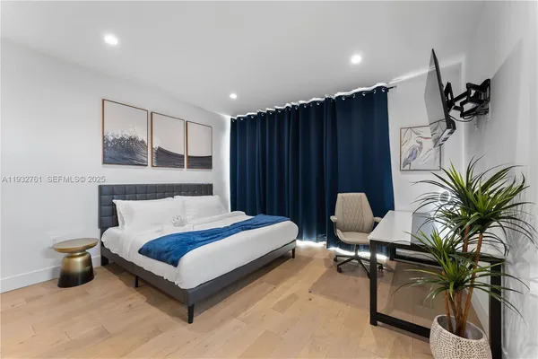 a spacious bedroom with a bed a desk and chair