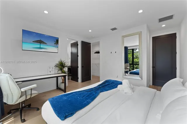 a bathroom with a granite countertop sink mirror and a toilet