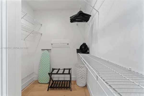 a bedroom with a bed and a refrigerator