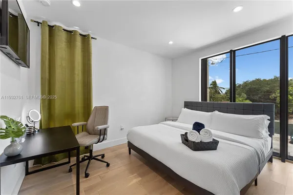 a en suite bathroom with a granite countertop sink and a mirror