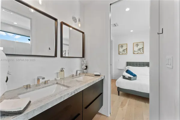 a bathroom with a granite countertop bathtub shower and toilet