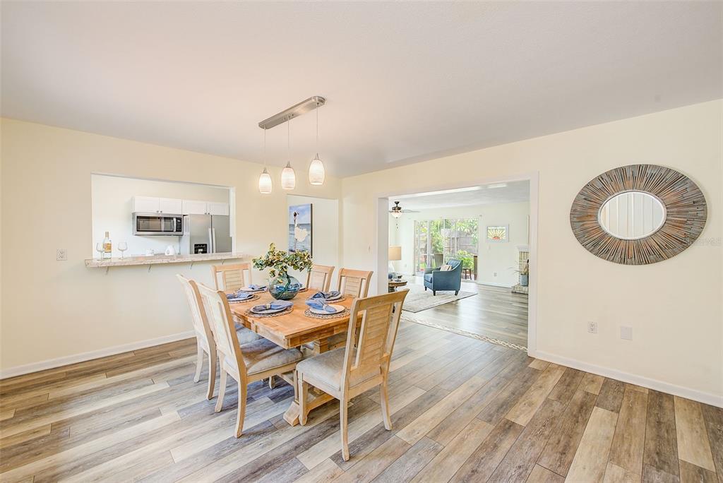 14079 Victoria Road Largo, FL 33774 - Photo 6 of 46 a view of a dining room with furniture and wooden floor