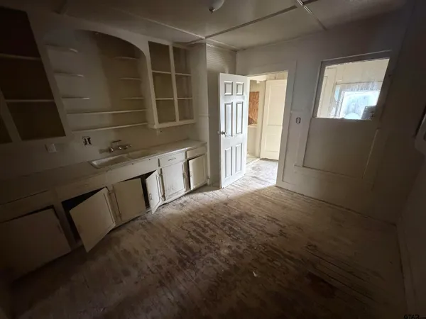 a room with a sink and cabinets