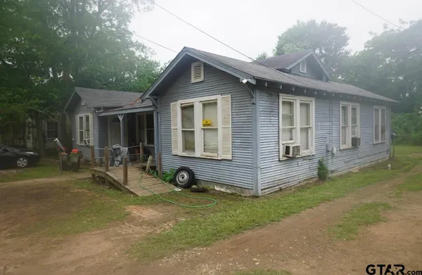 a front view of house with yard and outdoor seating