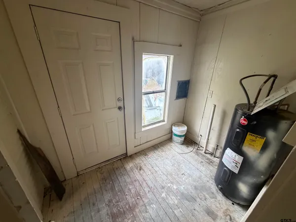 a view of an empty room and wooden floor
