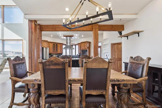 a dining room with furniture a chandelier and wooden floor
