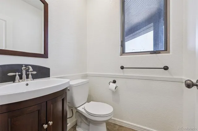 a bathroom with a sink a toilet and mirror