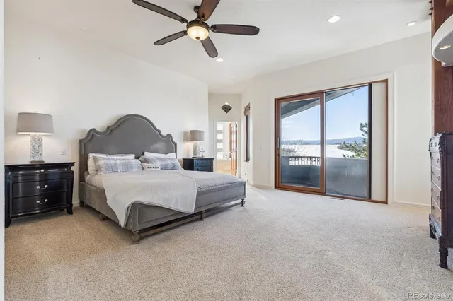 a spacious bedroom with a bed and a chandelier