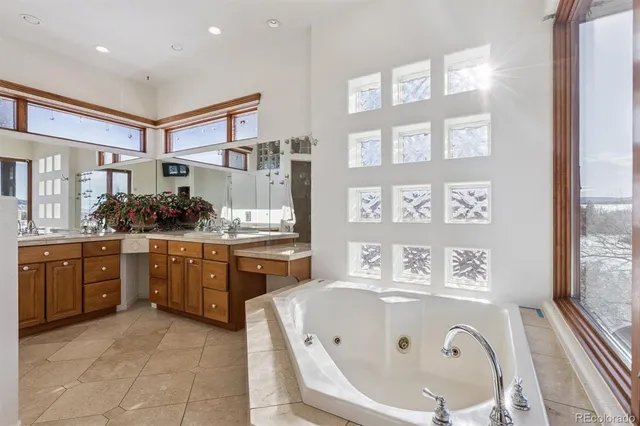 a bathroom with a tub sink and mirror