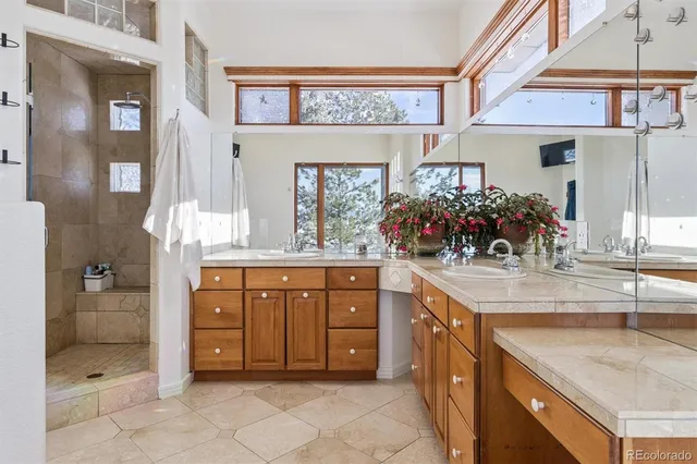 a spacious bathroom with a granite countertop sink and a mirror