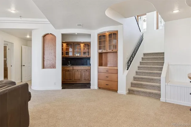 a kitchen with stainless steel appliances kitchen island granite countertop a refrigerator and a stove top oven