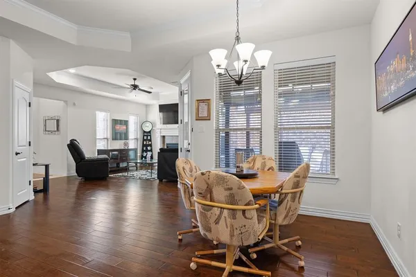 a view of a dining room with furniture wooden floor and chandelier