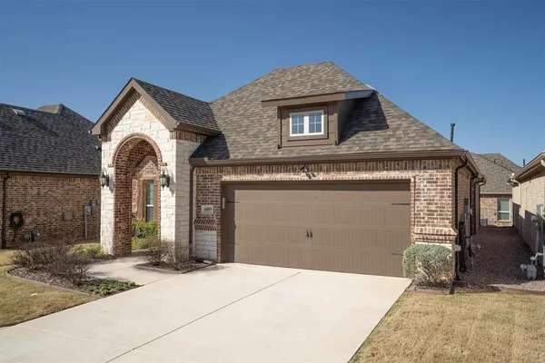 a view of a house with a yard and garage