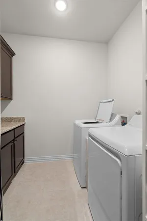 a utility room with a sink dryer and washer
