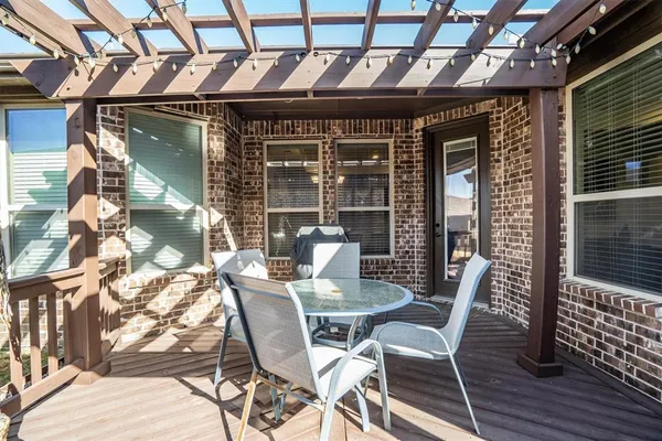 a view of a deck with a table and chairs