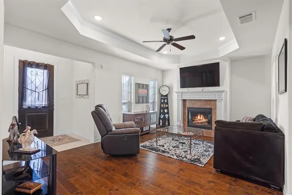 a living room with furniture a fireplace and a flat screen tv