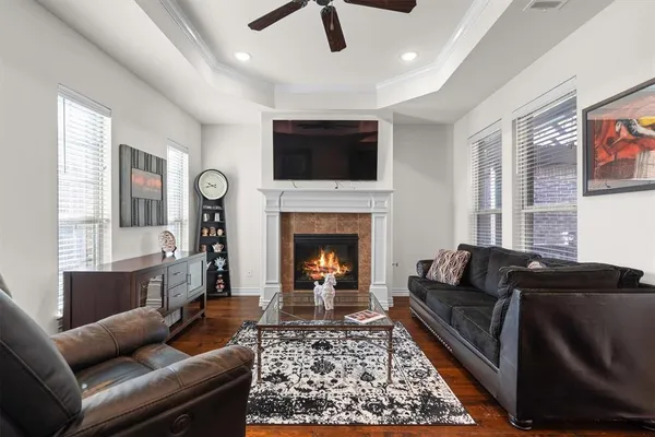 a living room with furniture a flat screen tv and a fireplace