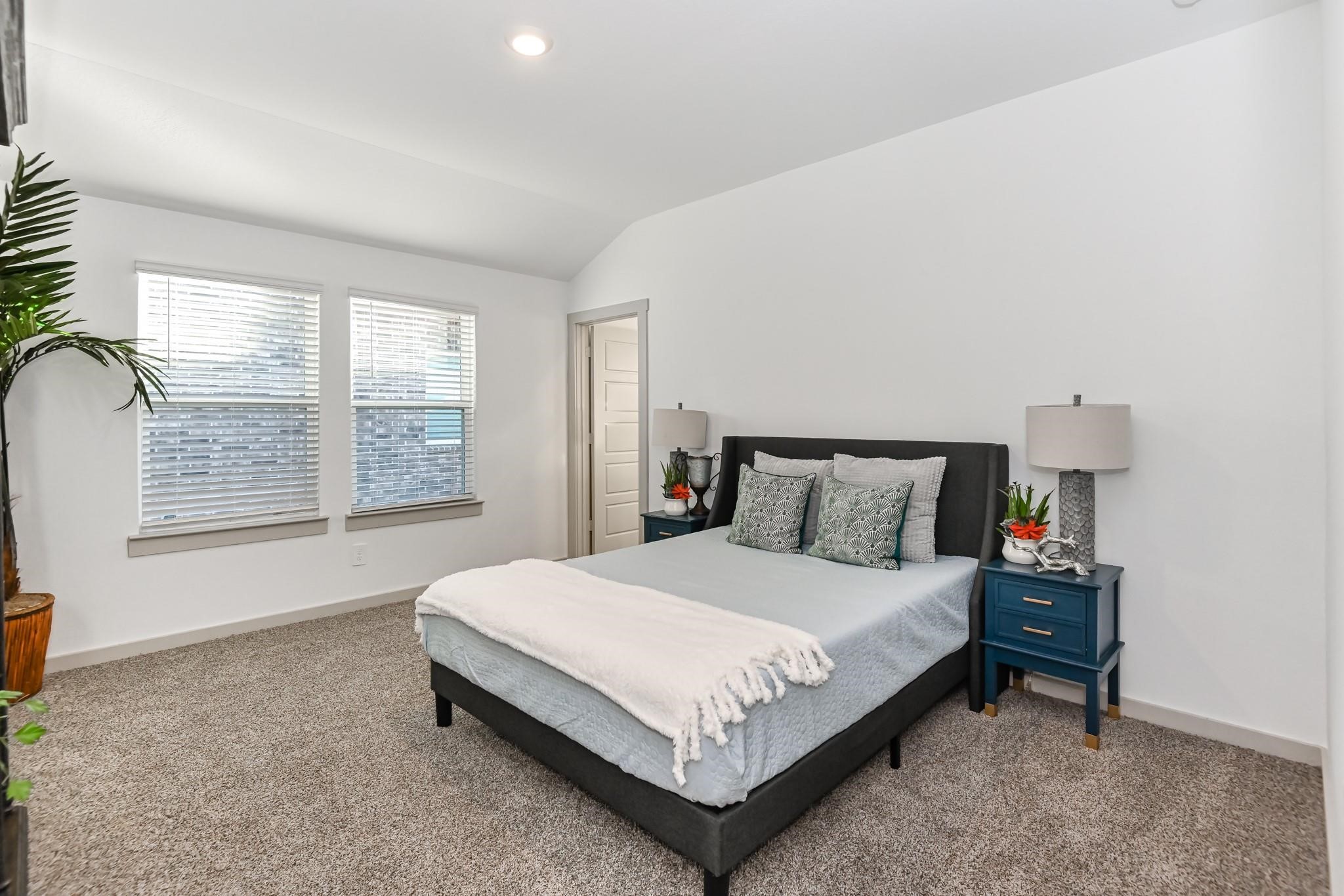 7811 Golden Rubia Lane Rosharon, TX 77583 - Photo 7 of 10 This bedroom is bright and spacious Primary Suite, featuring plush carpet, and two windows for natural light, offering a modern and comfortable atmosphere.