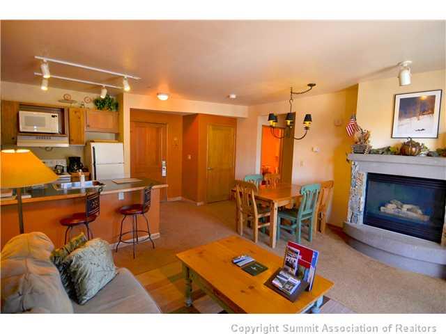 195 River Run Road, Unit 8037 Dillon, CO 80435 - Photo 2 of 25 a living room with furniture a rug and a chandelier