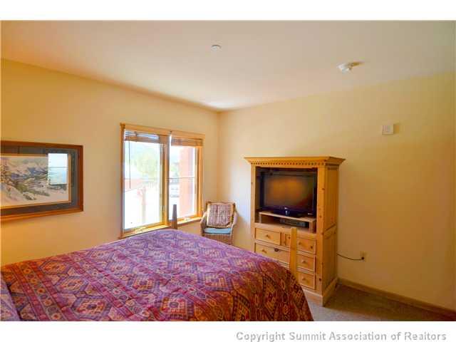 195 River Run Road, Unit 8037 Dillon, CO 80435 - Photo 12 of 25 a bedroom with a bed and a flat screen tv