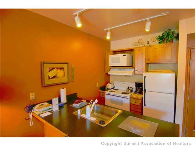 195 River Run Road, Unit 8037 Dillon, CO 80435 - Photo 5 of 25 a kitchen with sink refrigerator and microwave