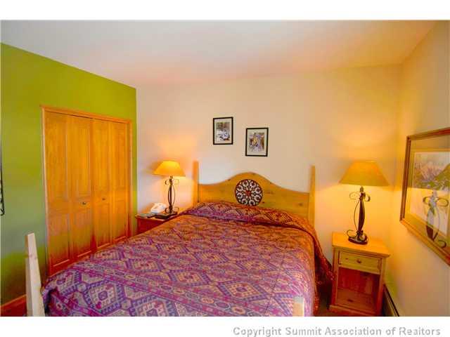 195 River Run Road, Unit 8037 Dillon, CO 80435 - Photo 6 of 25 a bedroom with a bed and wooden floor