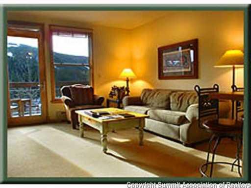 195 River Run Road, Unit 8037 Dillon, CO 80435 - Photo 10 of 25 a living room with furniture a lamp and a large window