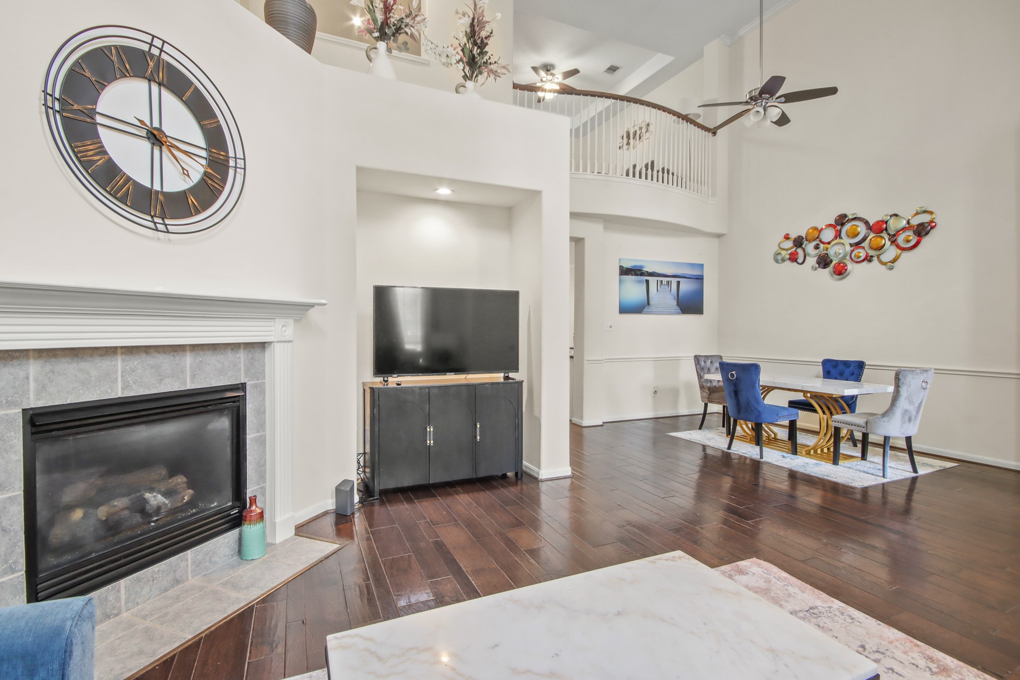 a living room with furniture a fireplace and a flat screen tv