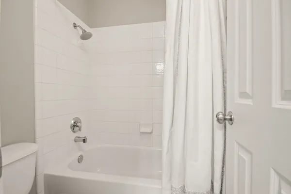 a white bath tub with a shower curtain