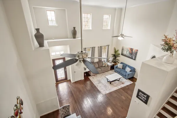 a living room with furniture and wooden floor