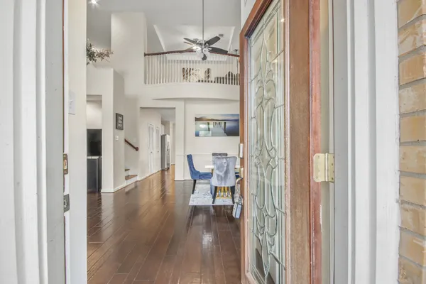 a view of a hallway with wooden floor windows and entryway