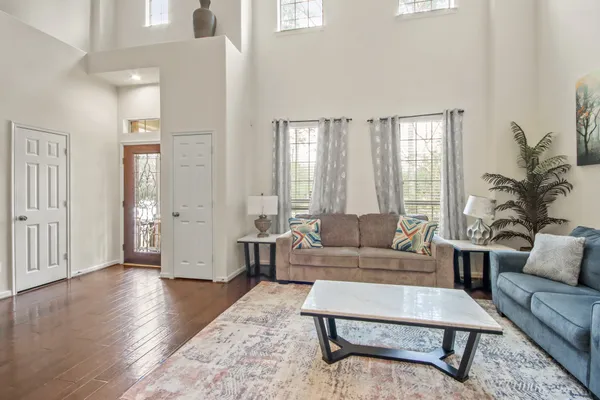 a living room with furniture and wooden floor
