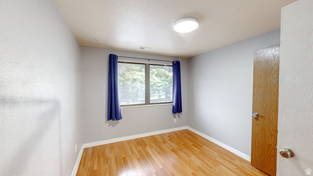 630 1100 West Provo, UT 84601 - Photo 14 of 64 Room featuring wood-finish flooring, a window with natural light, and a flush-mount ceiling light fixture