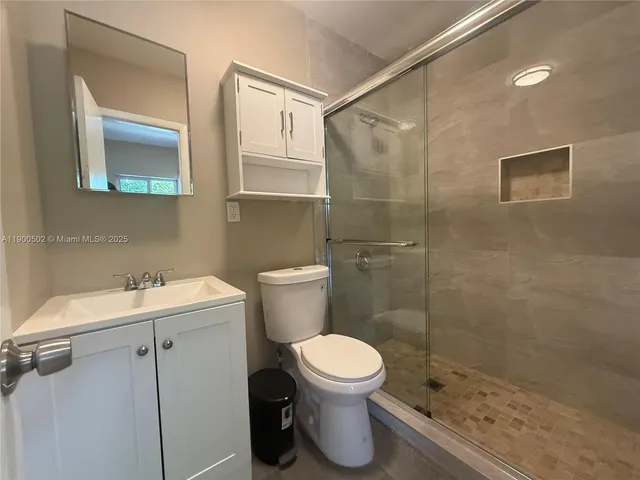 a bathroom with a toilet sink and shower