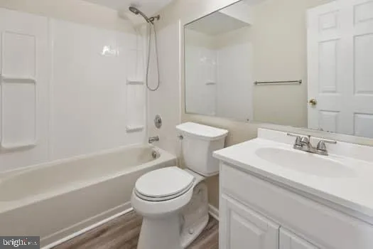 a bathroom with a sink toilet vanity and shower
