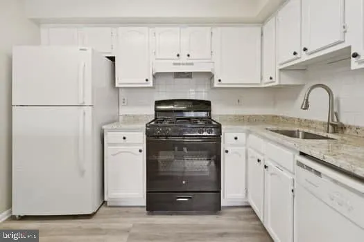 a kitchen with a white stove and refrigerator