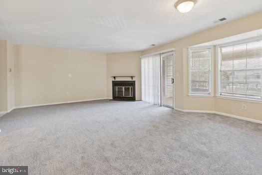 106 Lassen Court, Unit 5 Princeton, NJ 08540 - Photo 6 of 19 an empty room with a fireplace and large window