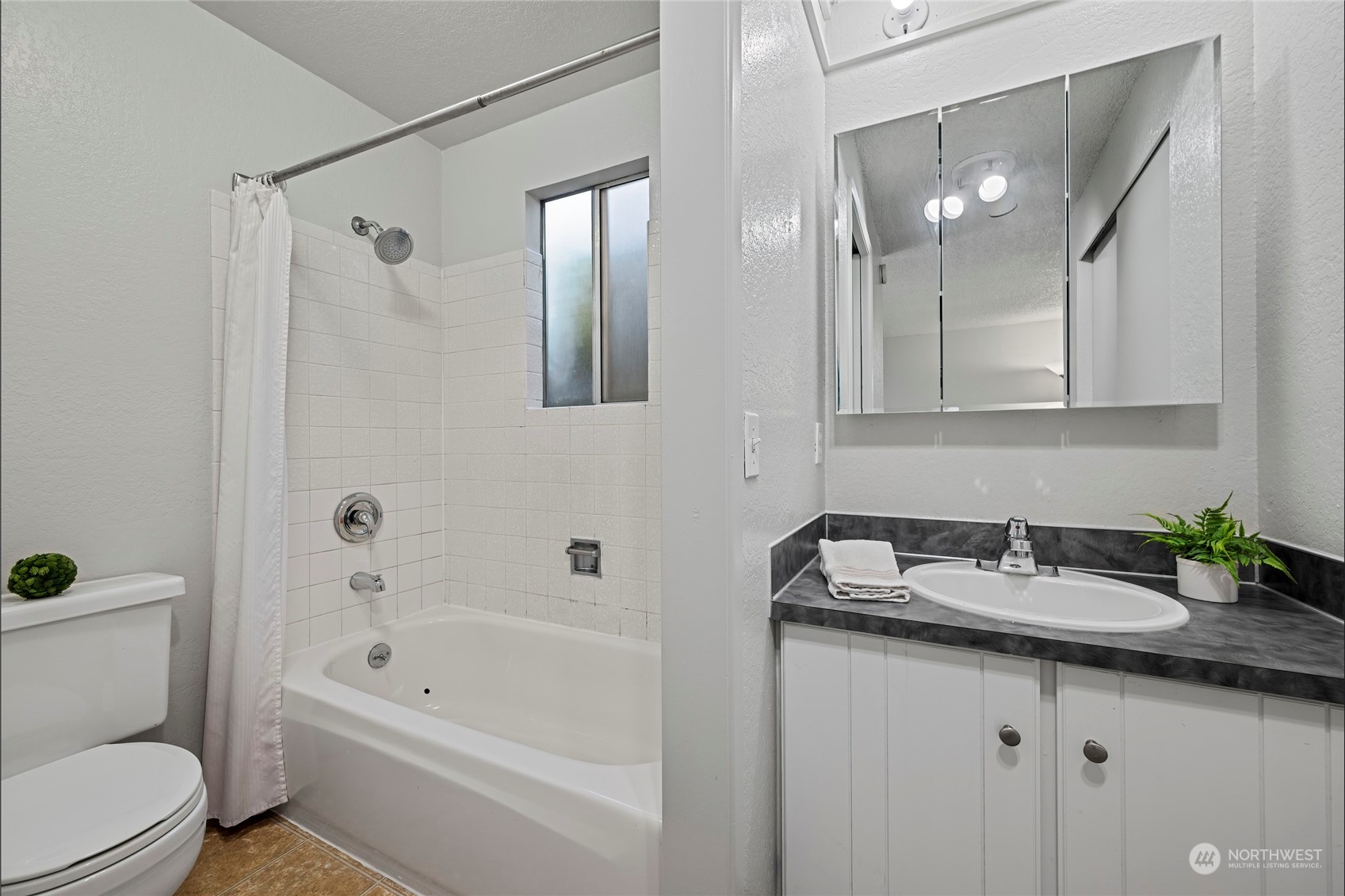 704 221st Street Southwest Bothell, WA 98021 - Photo 12 of 21 a bathroom with a granite countertop sink a toilet and shower
