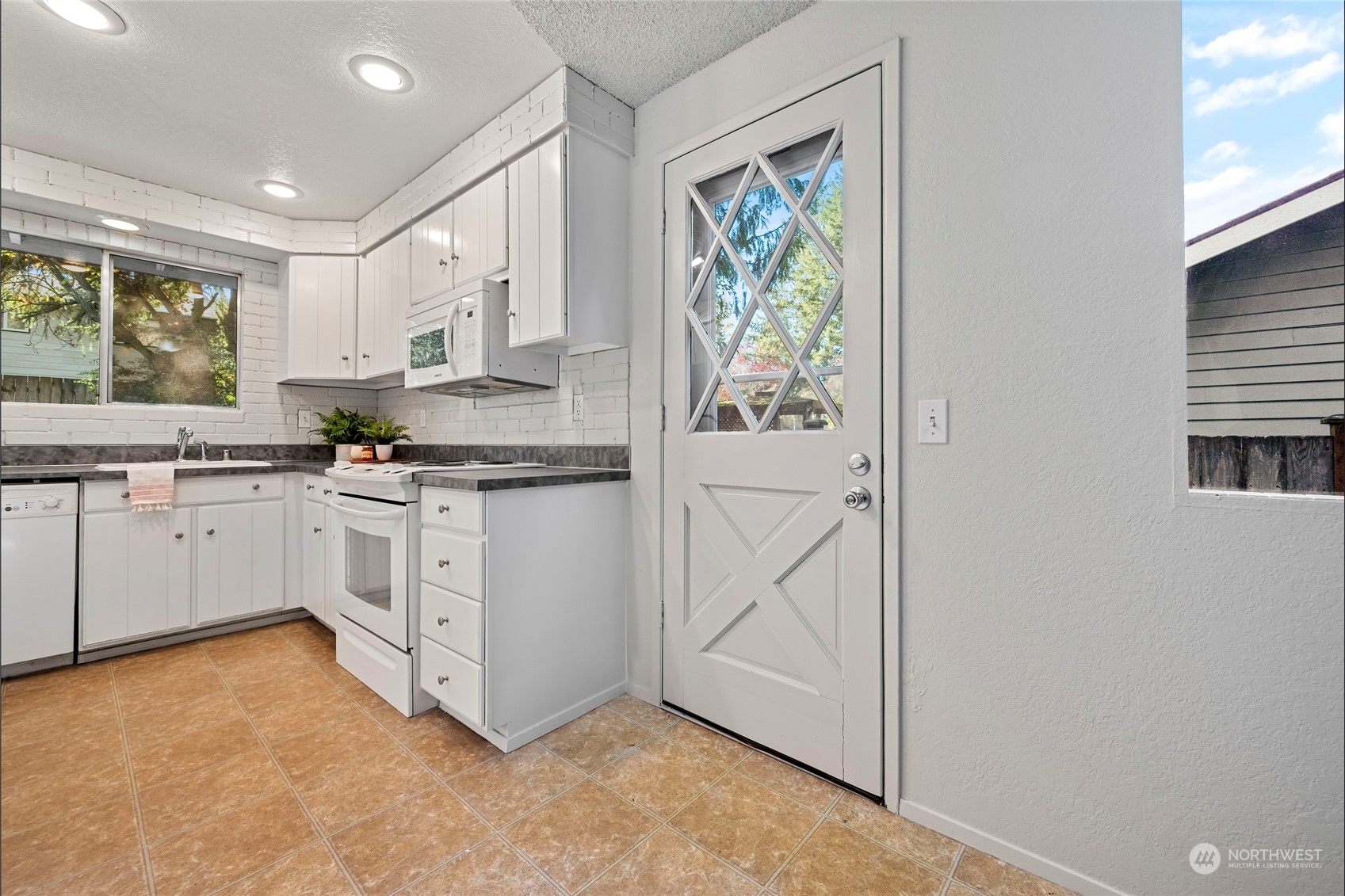 704 221st Street Southwest Bothell, WA 98021 - Photo 15 of 21 a kitchen with white cabinets and white appliances