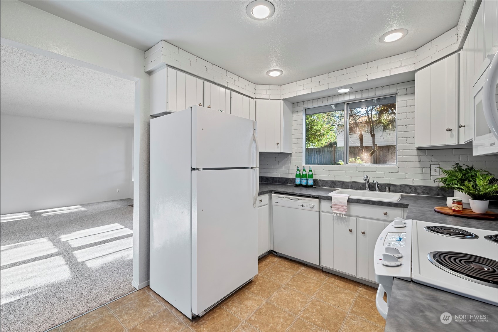 704 221st Street Southwest Bothell, WA 98021 - Photo 8 of 21 a kitchen with stainless steel appliances a refrigerator sink and cabinets