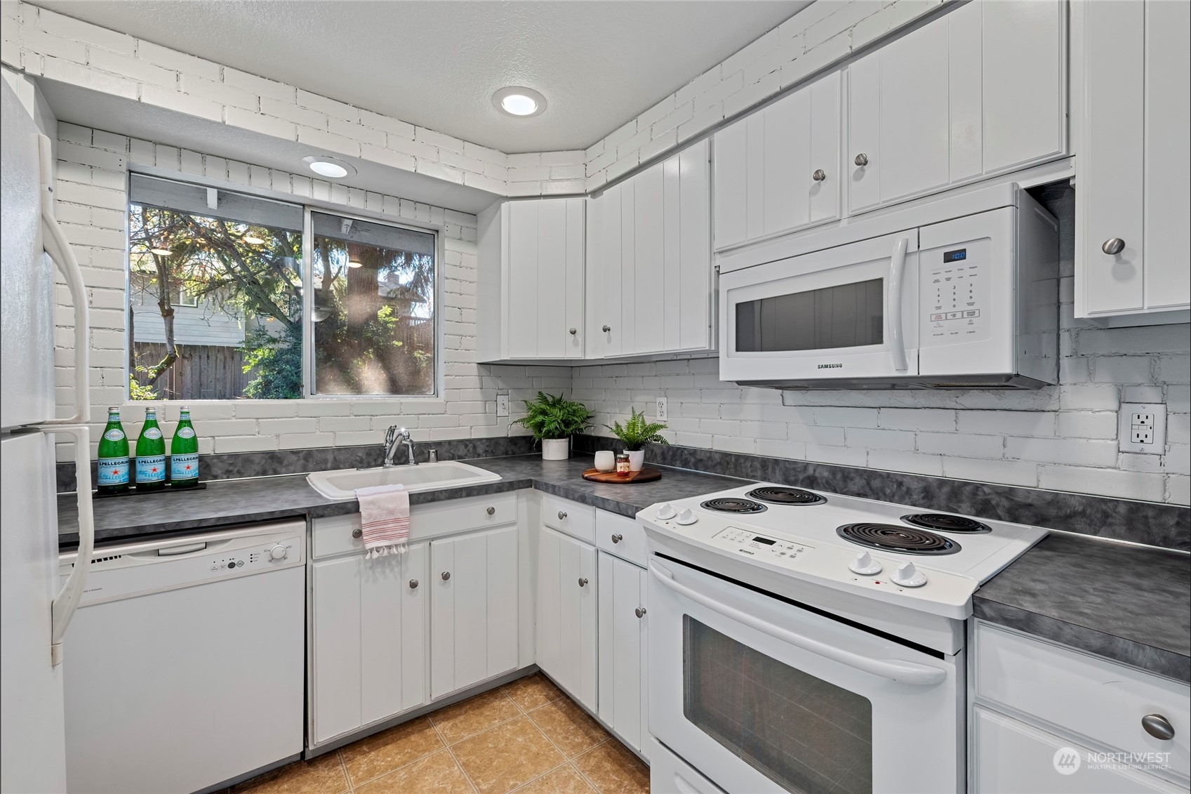 704 221st Street Southwest Bothell, WA 98021 - Photo 10 of 21 a kitchen with cabinets appliances a sink and a window