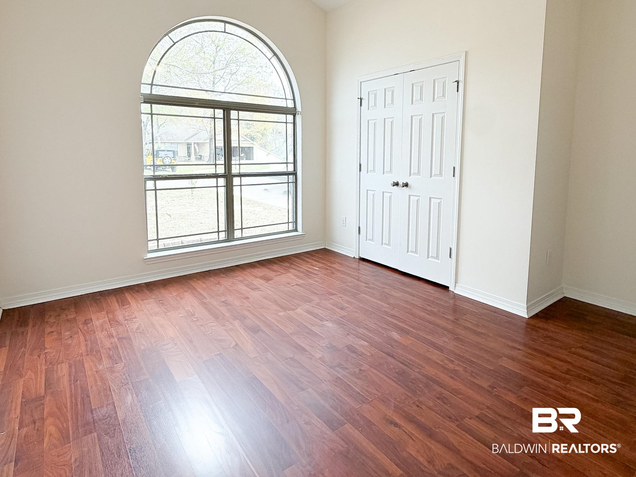 7332 Raintree Lane Gulf Shores, AL 36542 - Photo 17 of 21 Unfurnished bedroom featuring a closet and dark wood-style floors