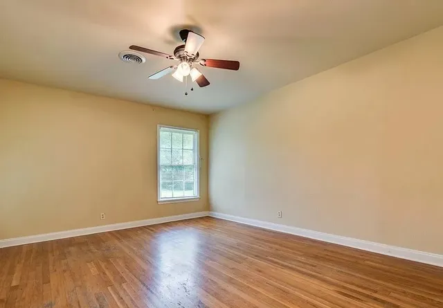 a large kitchen with granite countertop a large window and stainless steel appliances